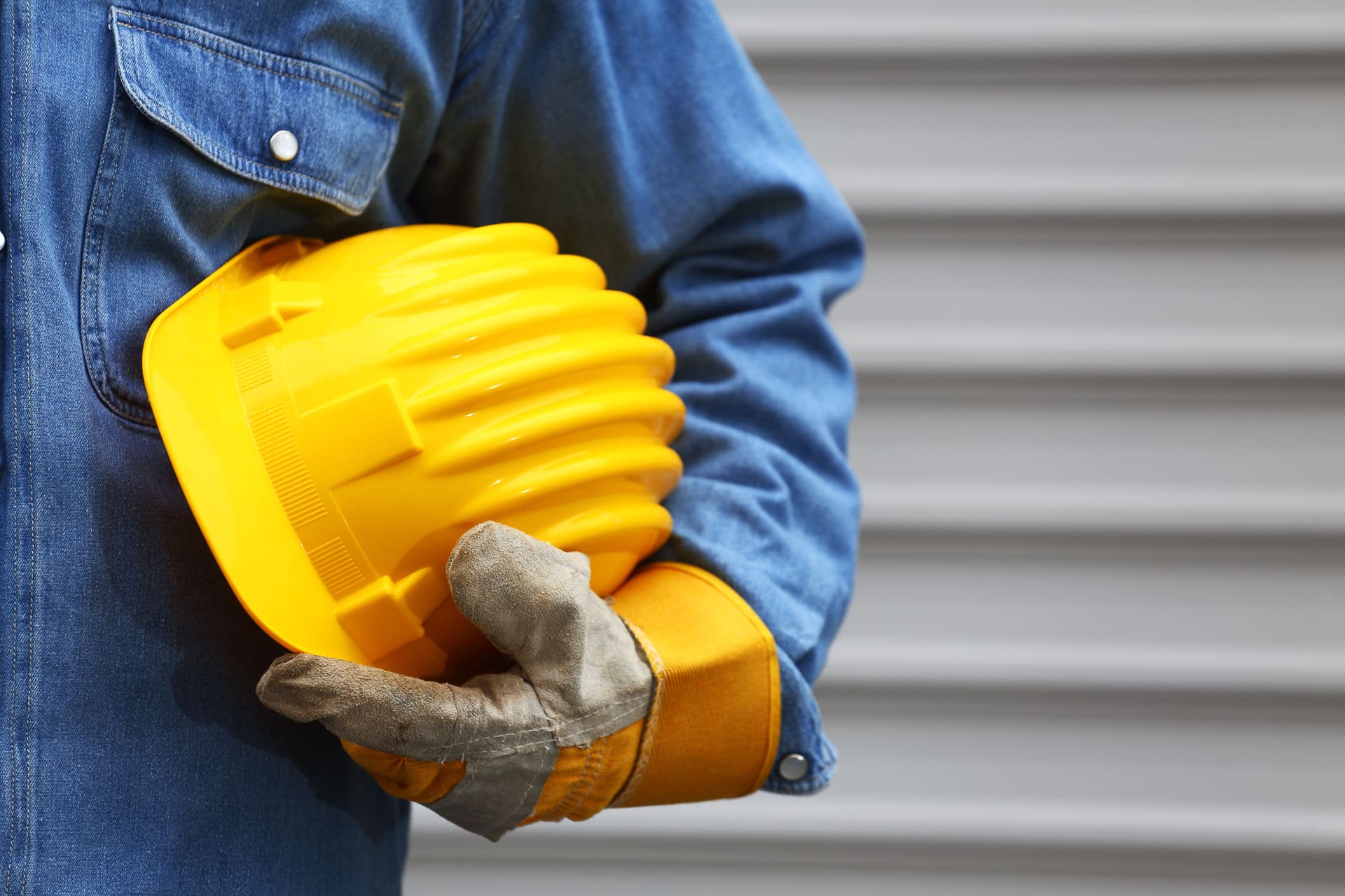 A man holding a yellow hard hat