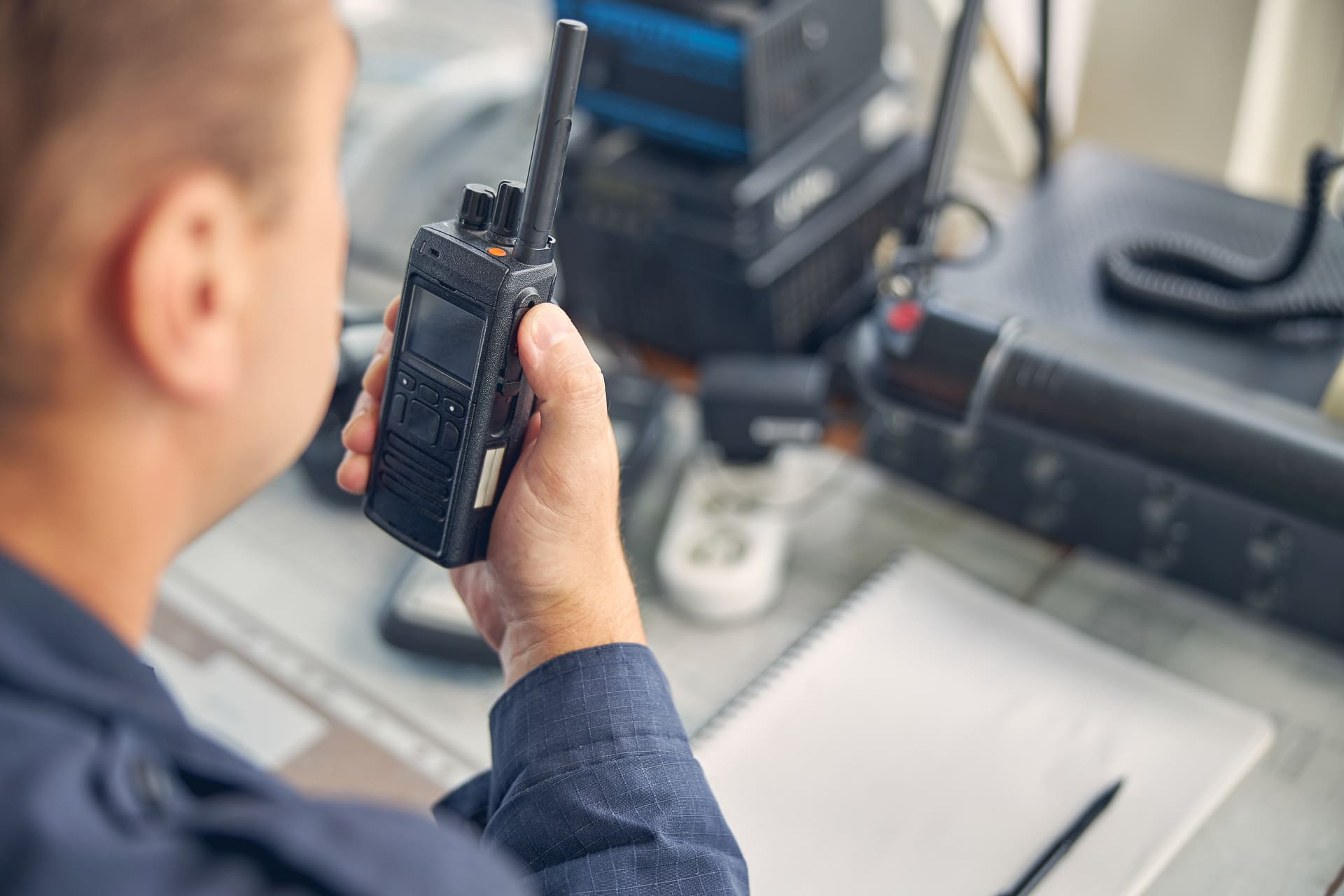 A man with a walkie talkie in hand