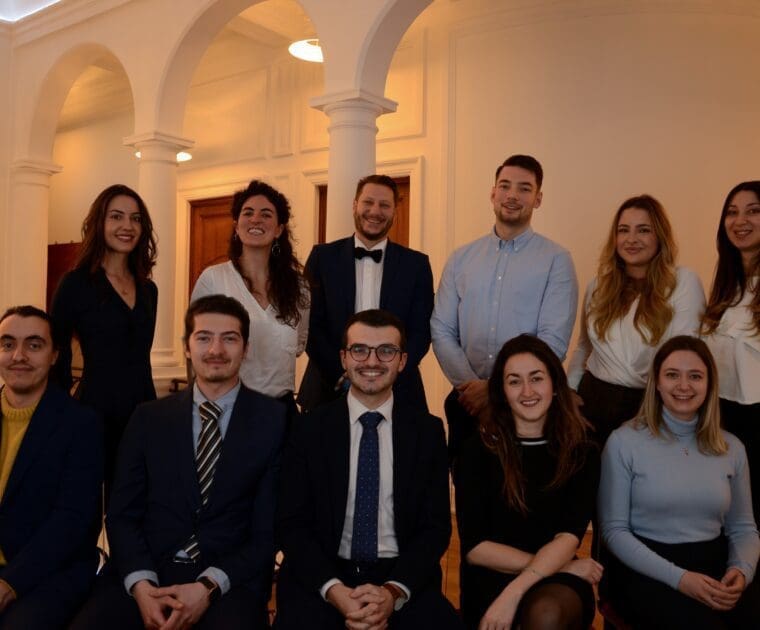 A group of smiling people at official event