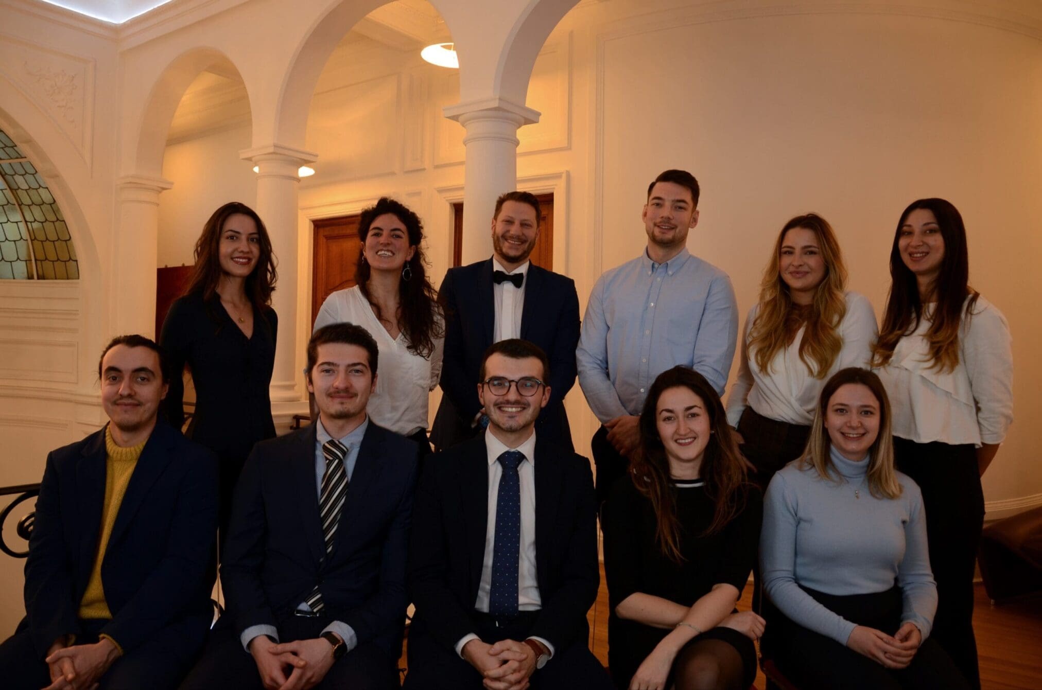 A group of smiling people at official event