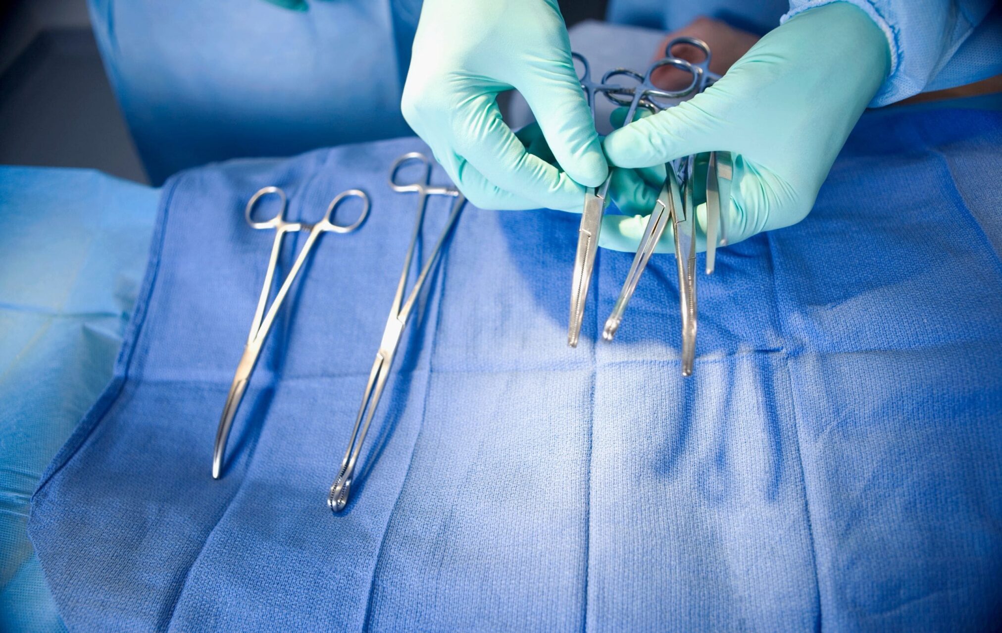 A person holds surgical scissors