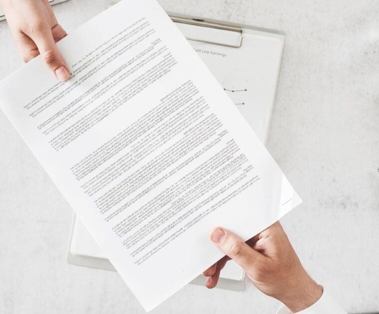 Two hands holding a paper