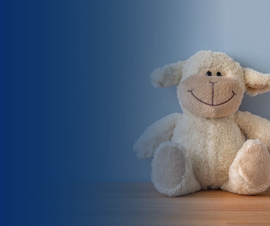 A plush sheep sits on a table